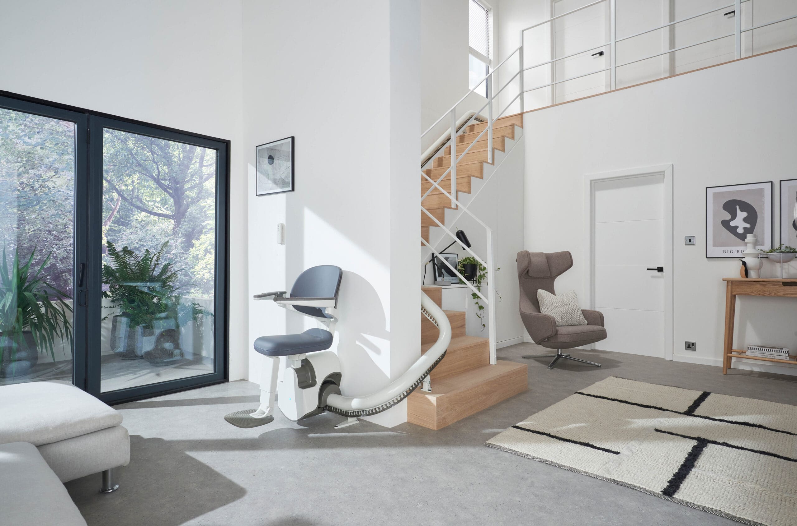 Flow X curved stairlift bottom of stairs ready to travel