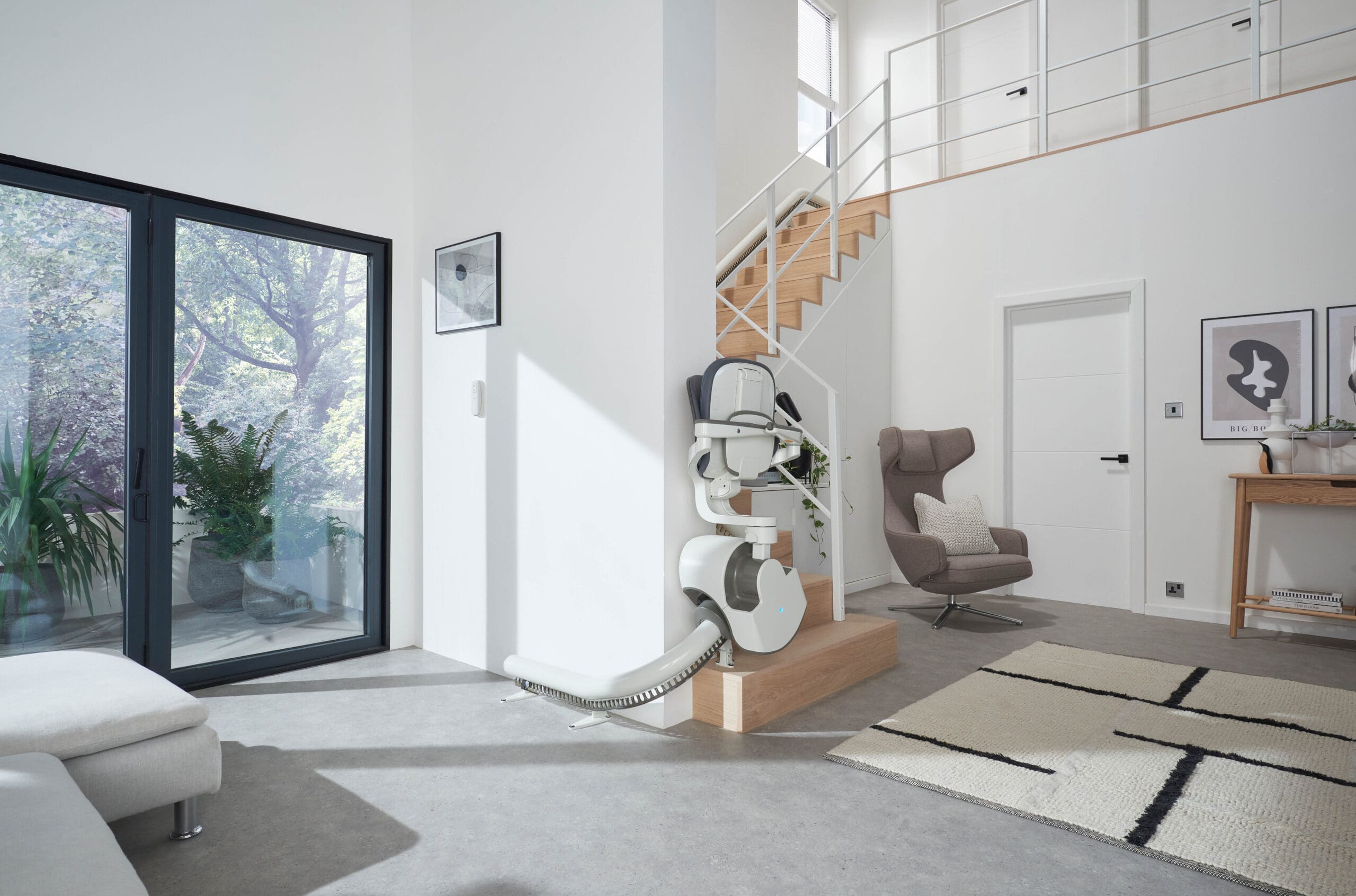 Flow X curved stairlift not in use and folded on park point
