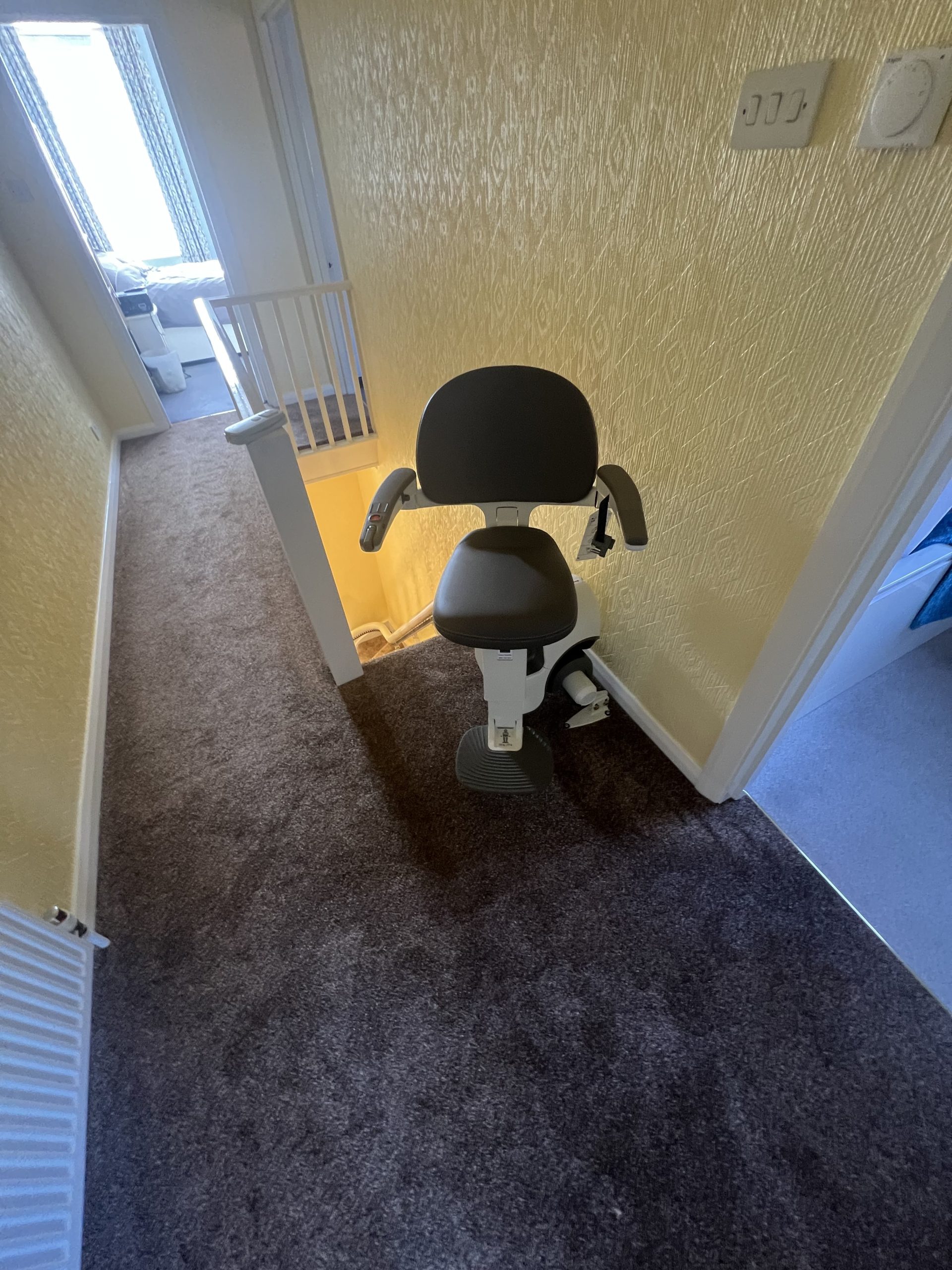 Flow X curved stairlift specialist example rotated at top of narrow stairs