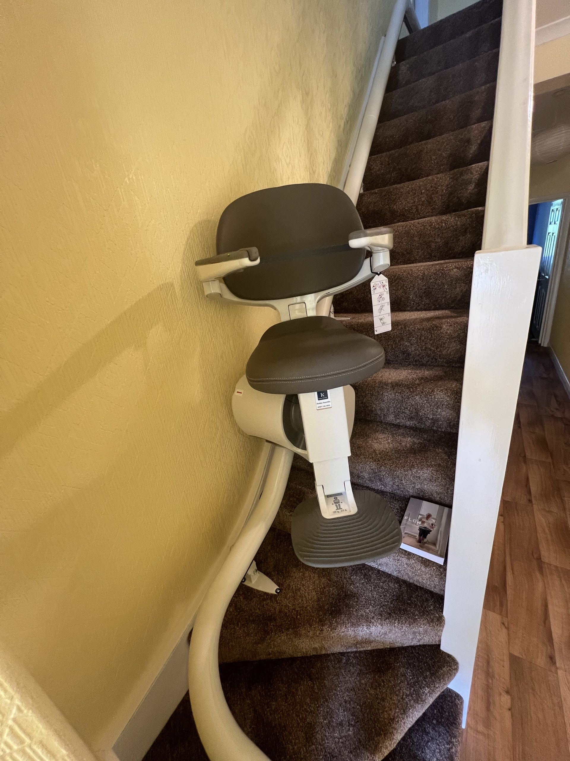 Flow X curved stairlift specialist example travelling at angle up staircase