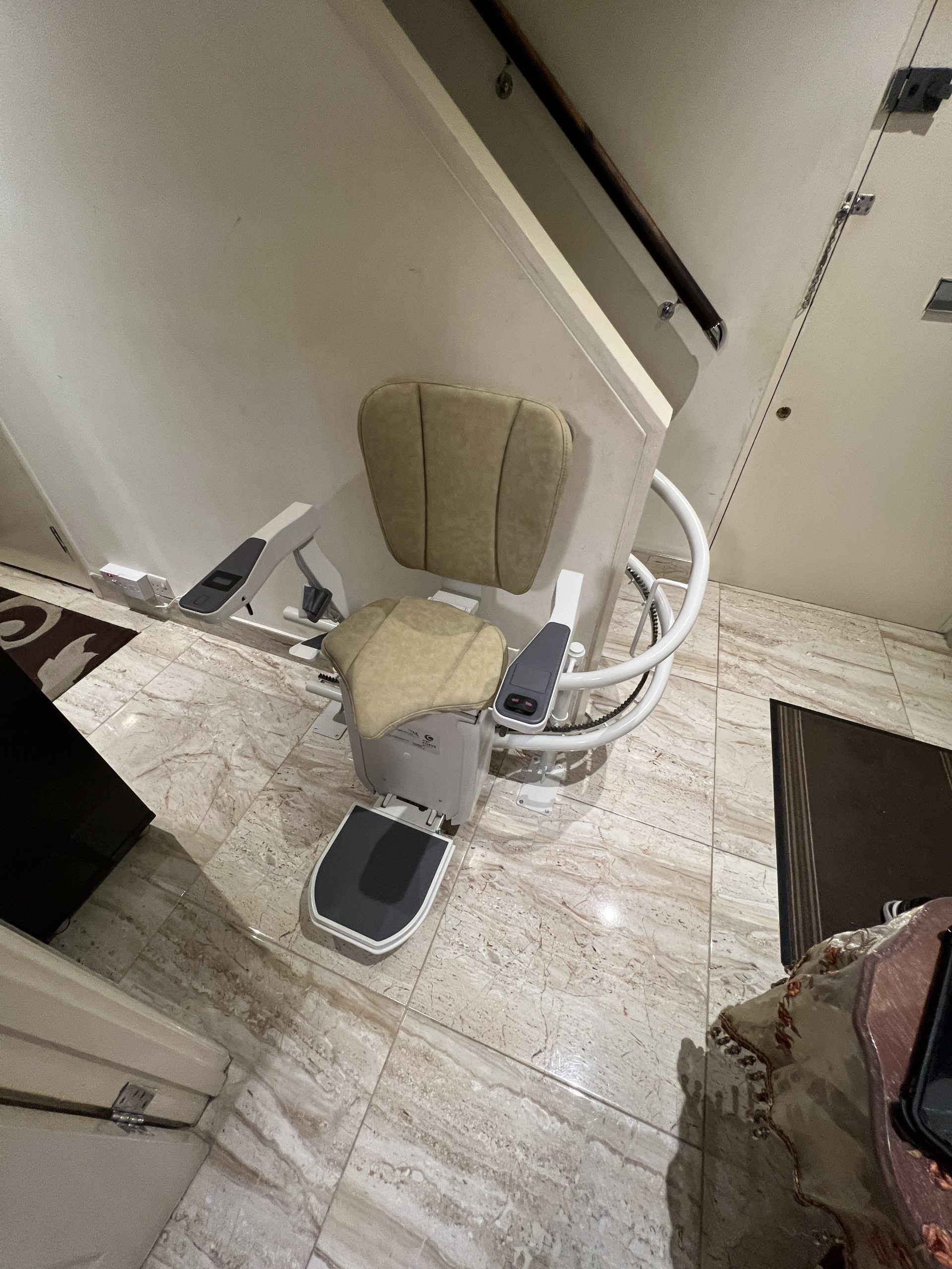 Platinum Ergo Curve curved stairlift heavy duty specialist example ready to travel at bottom of staircase