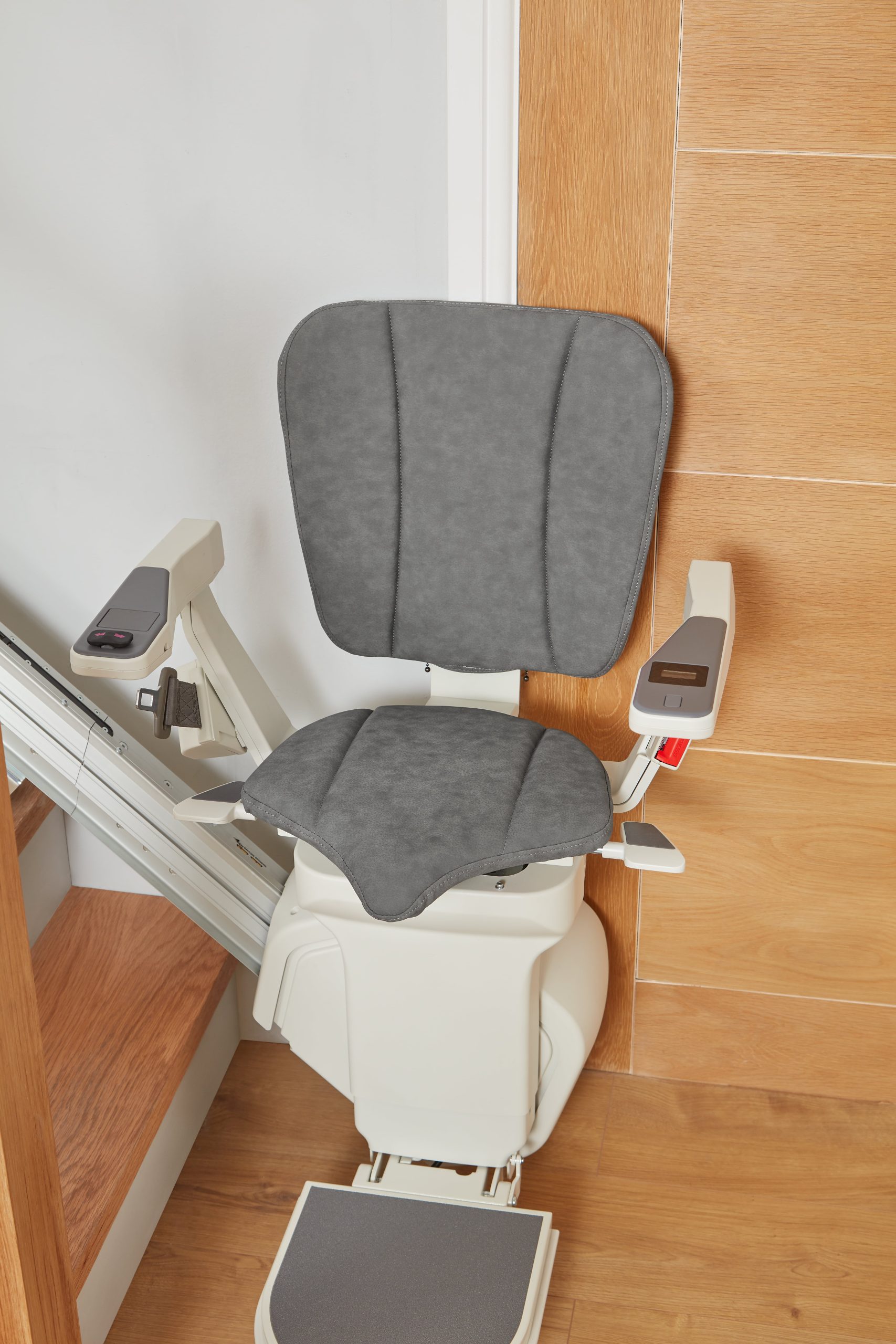 Platinum Ergo Straight straight stairlift at bottom of staircase Ergo seat pad