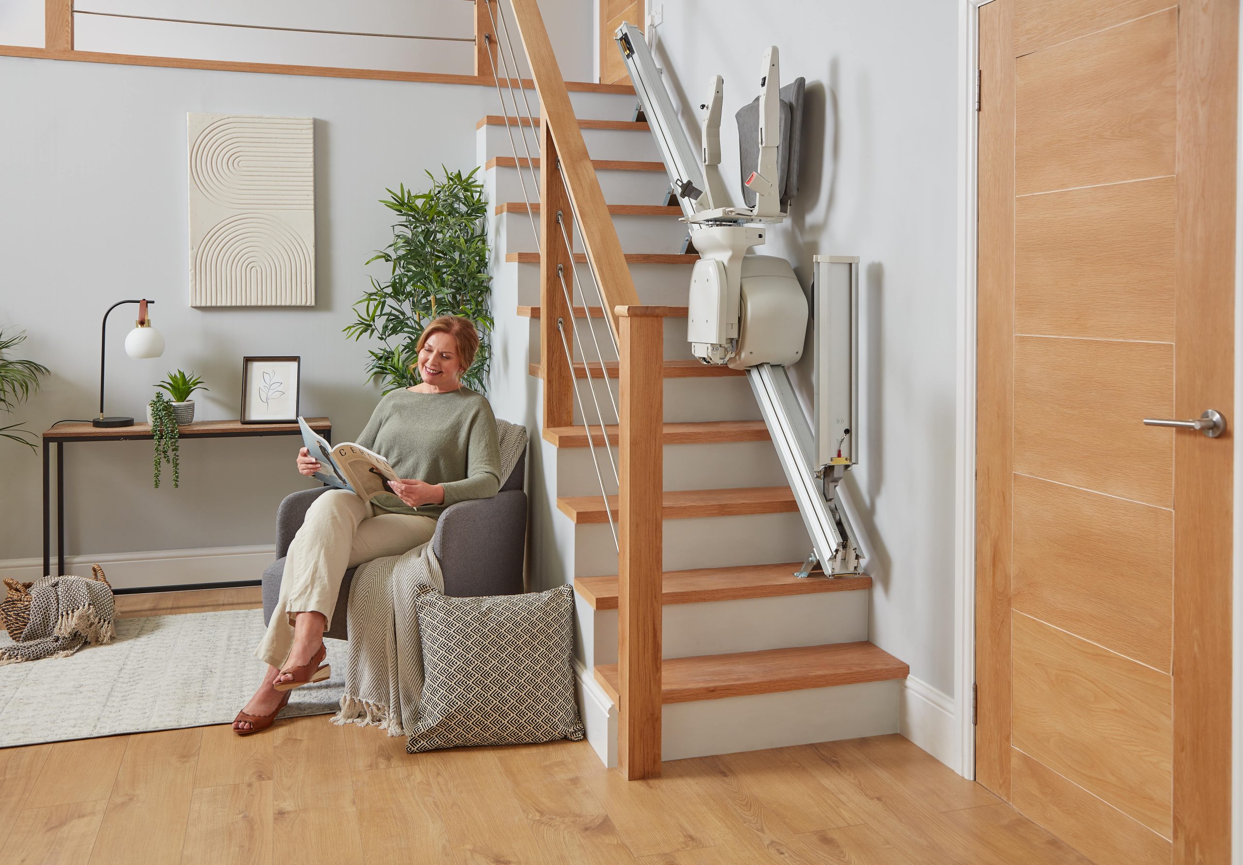 Platinum Ergo Straight straight stairlift powered hinge rail folded up seat parked halfway up staircase