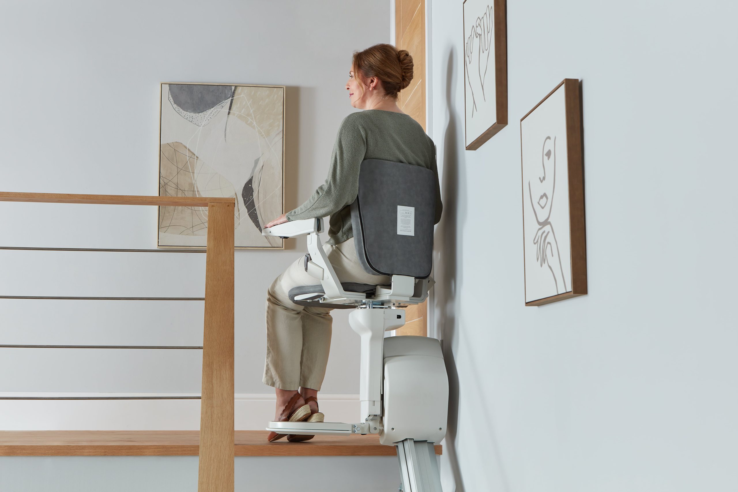 Platinum Ergo Straight straight stairlift powered swivel user on seat rotating at top of stairs