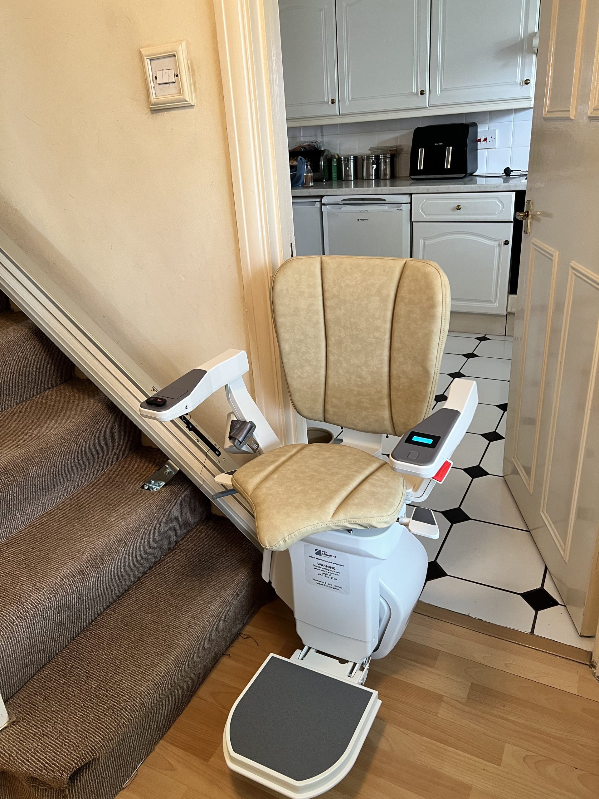 Platinum Ergo Straight straight stairlift specialist example bottom of stairs powered hinge folded down ready to travel