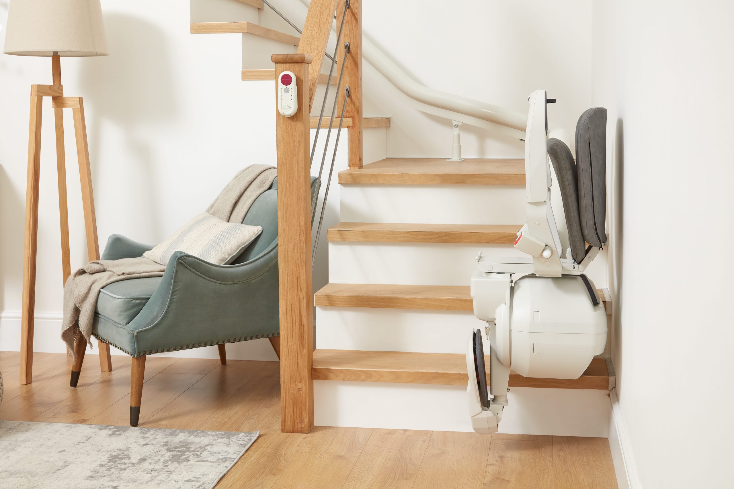 Platinum Ergo Ultimate curved stairlift parked with seat and arms and footrest folded