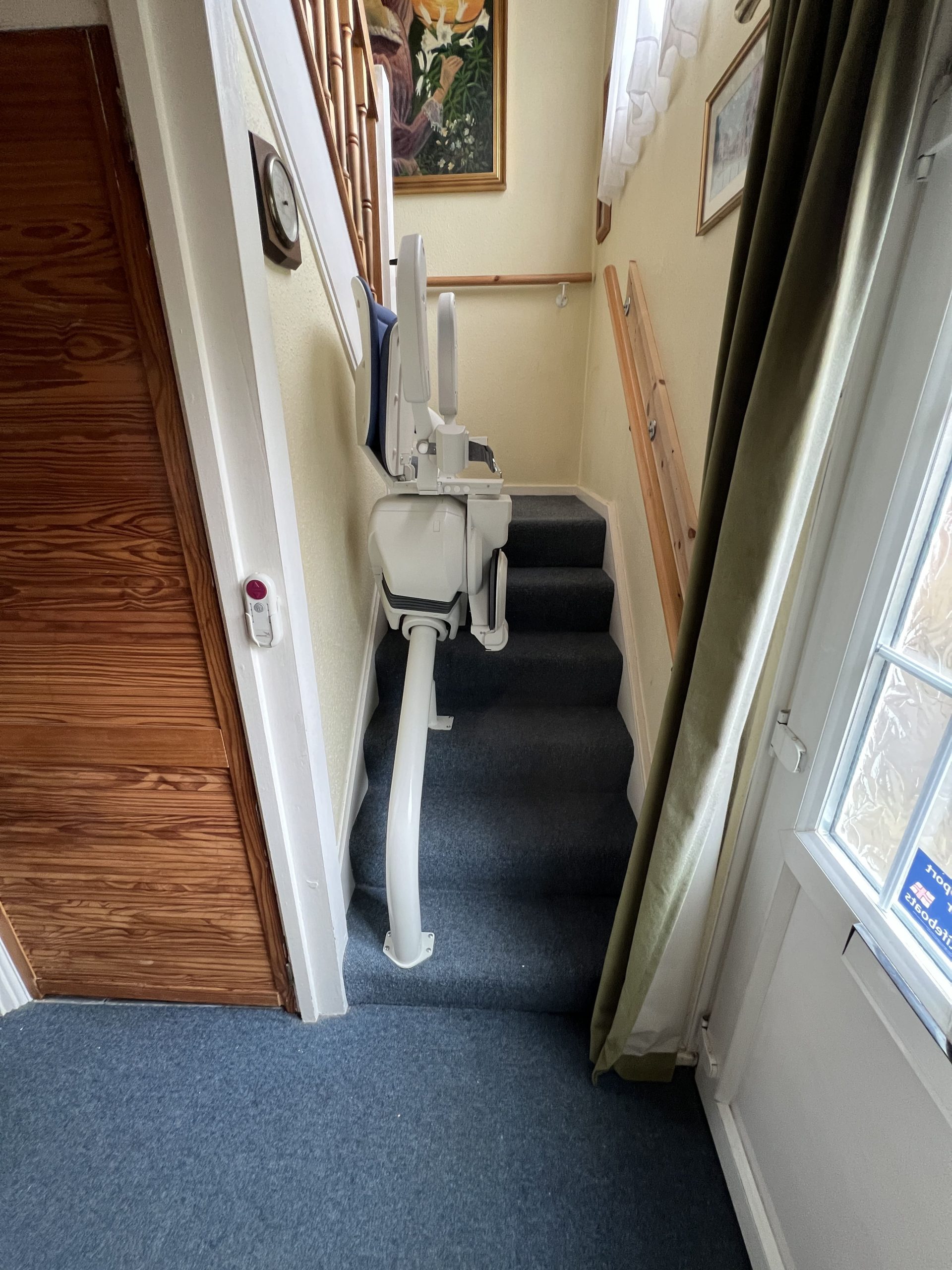 Platinum Ergo Ultimate curved stairlift specialist example first step start rail seat folded and parked on stairs