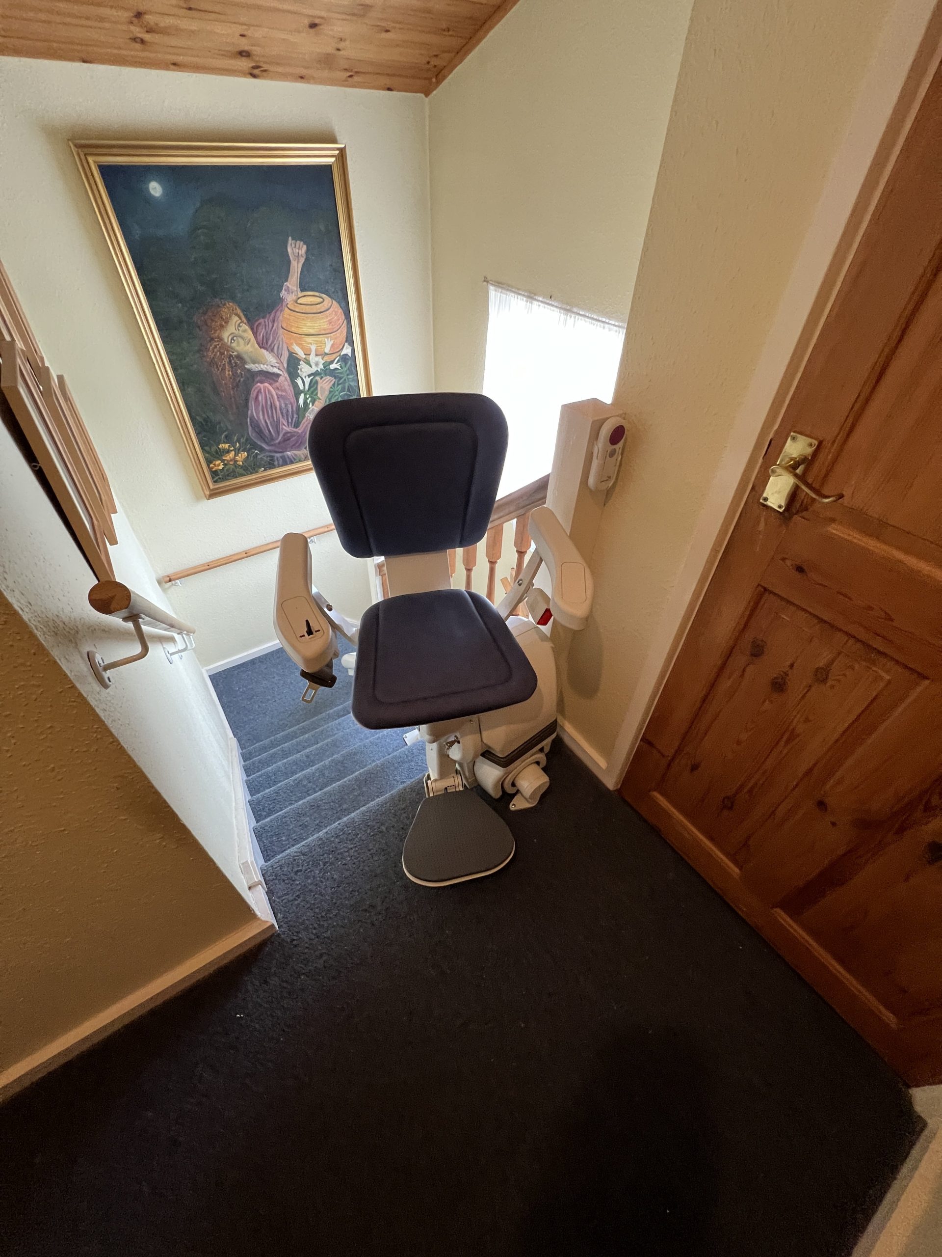 Platinum Ergo Ultimate curved stairlift specialist example rotated at top of stairs for user to get on or off